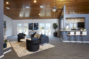 A living room with a grey couch and a white table.